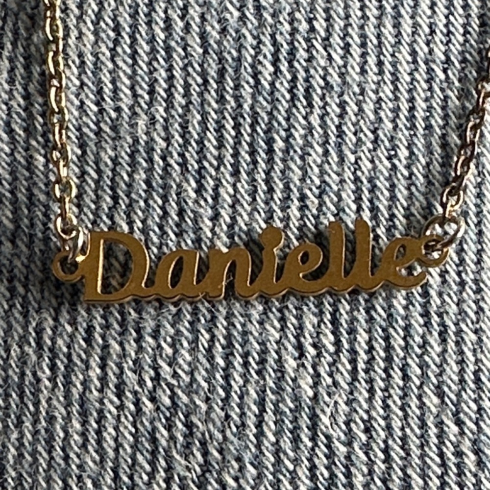 This is a Marina DeBuchi personalized gold-tone necklace.